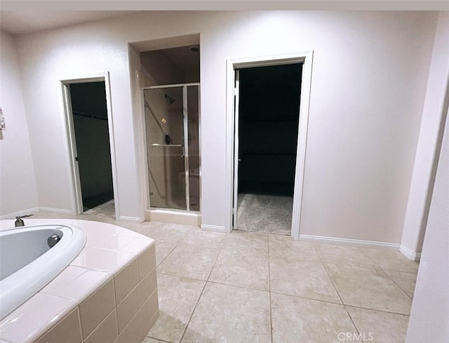 bathroom with tile patterned floors and separate shower and tub