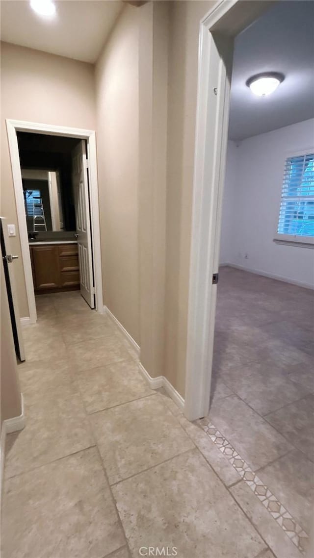 hallway featuring light tile patterned floors