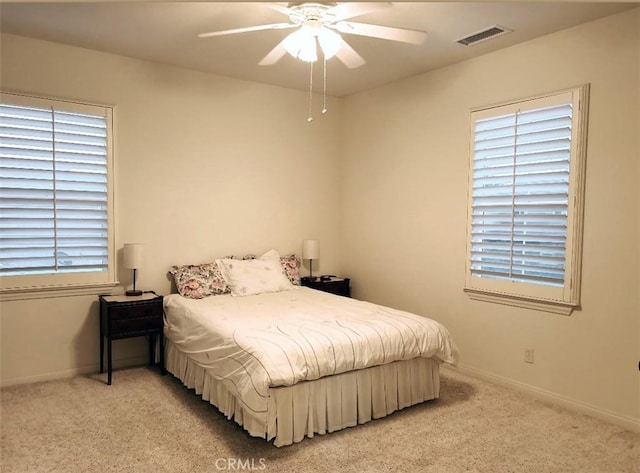 bedroom with light carpet and ceiling fan