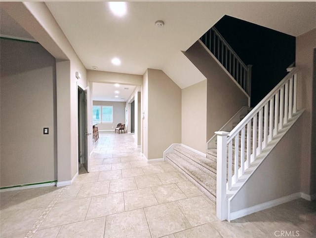 hall with light tile patterned floors