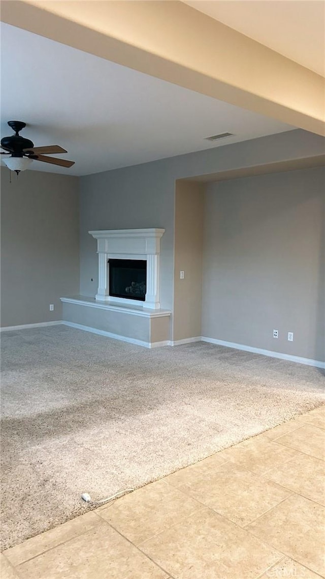 unfurnished living room with ceiling fan