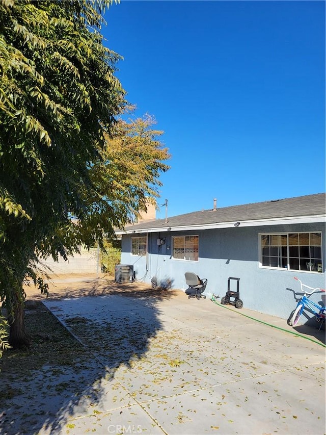 rear view of property with central AC unit