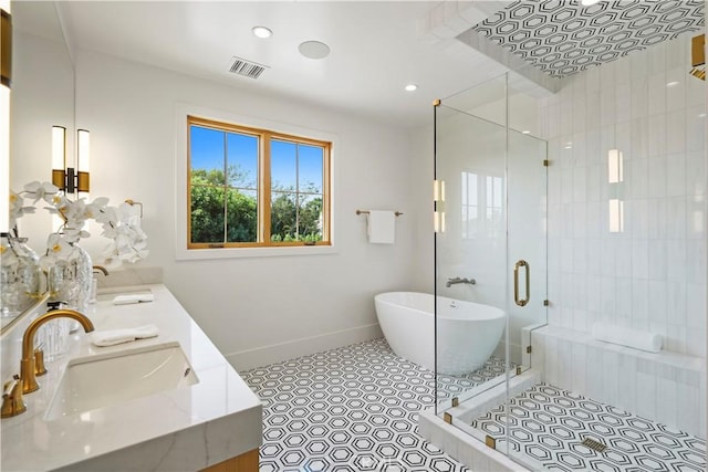 bathroom with tile patterned floors, sink, and plus walk in shower