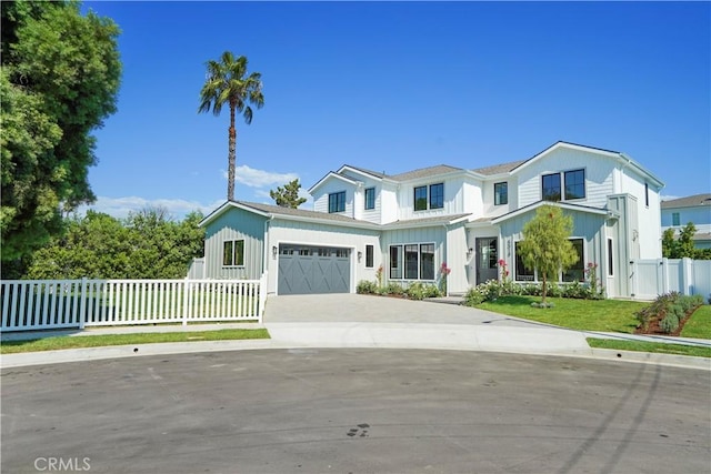 view of front of house with a front yard and a garage