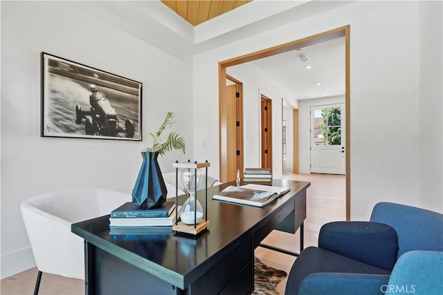 home office with hardwood / wood-style flooring and wood ceiling