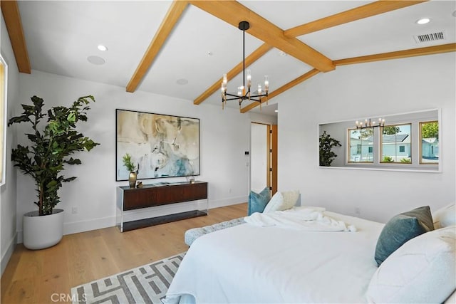 bedroom featuring lofted ceiling with beams, a chandelier, and light wood-type flooring