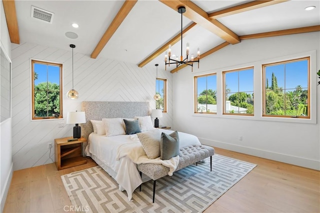 bedroom with a notable chandelier, vaulted ceiling with beams, light hardwood / wood-style floors, and multiple windows