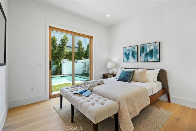 bedroom featuring access to exterior and light hardwood / wood-style floors