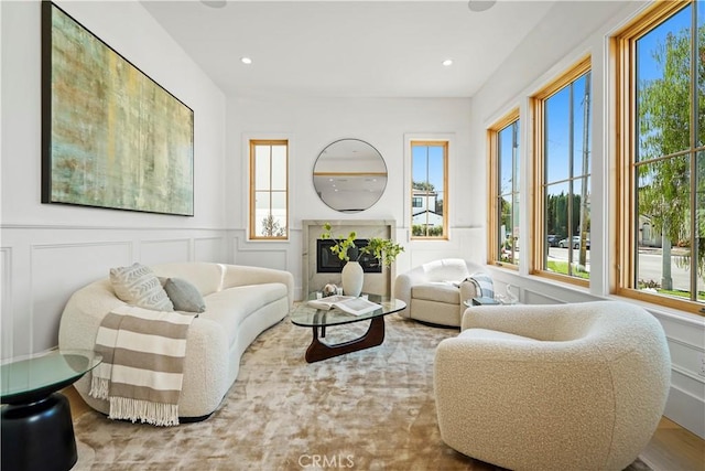 living room featuring a premium fireplace and hardwood / wood-style floors