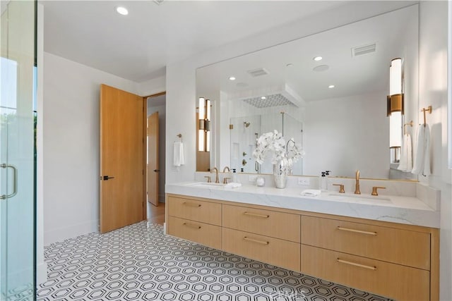 bathroom featuring vanity and a shower with shower door