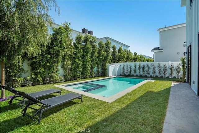 view of pool with an in ground hot tub and a yard