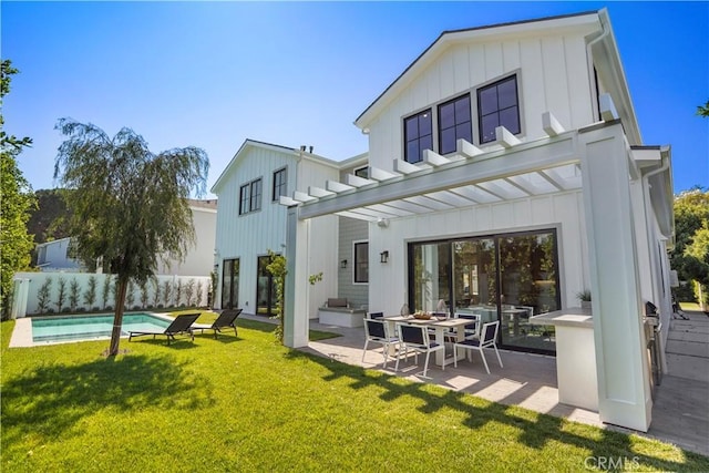 rear view of house featuring a pergola, a patio area, a yard, and a fenced in pool