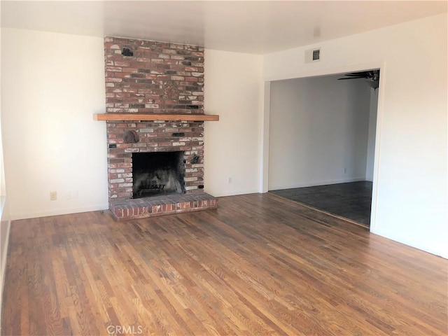 unfurnished living room with a fireplace and hardwood / wood-style floors