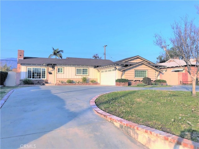 ranch-style house with a garage and a front yard