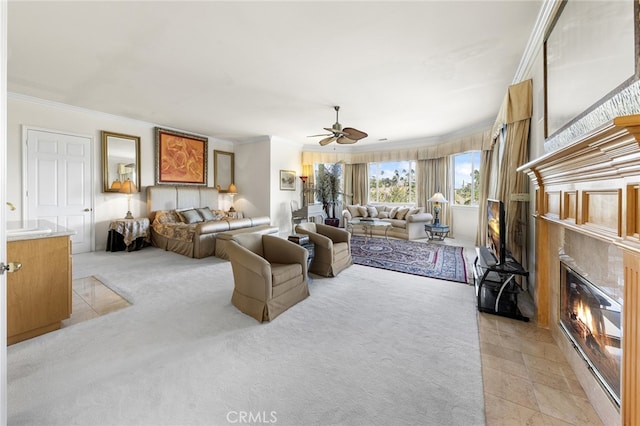 carpeted living room featuring ceiling fan and crown molding