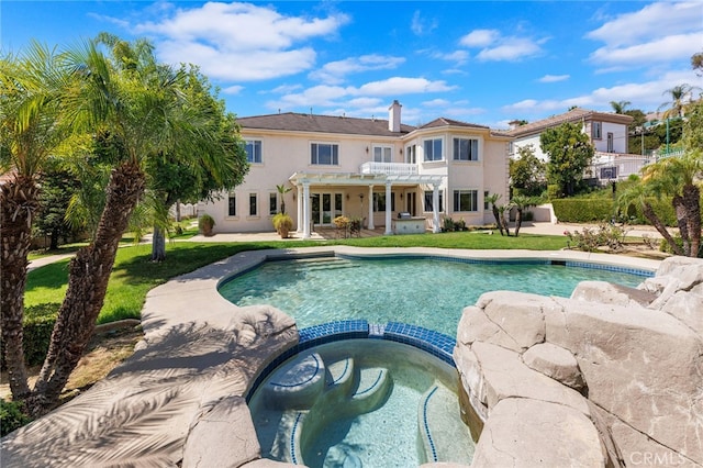 view of swimming pool with an in ground hot tub and a pergola