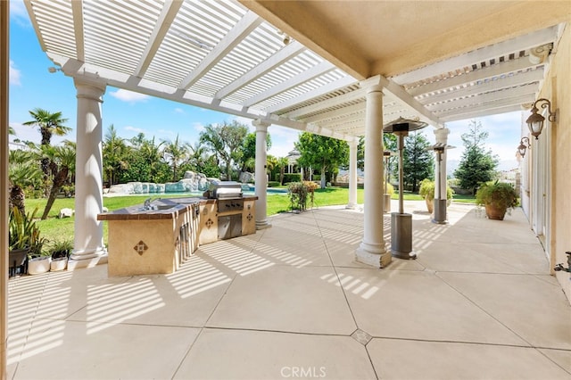 view of patio / terrace with a pergola, a grill, and exterior kitchen