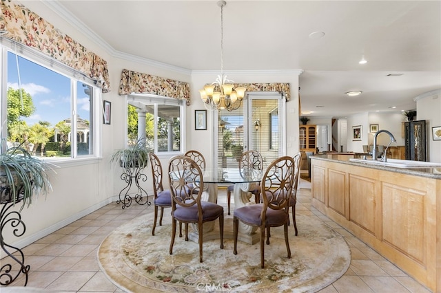 tiled dining room with sink, crown molding, and a notable chandelier