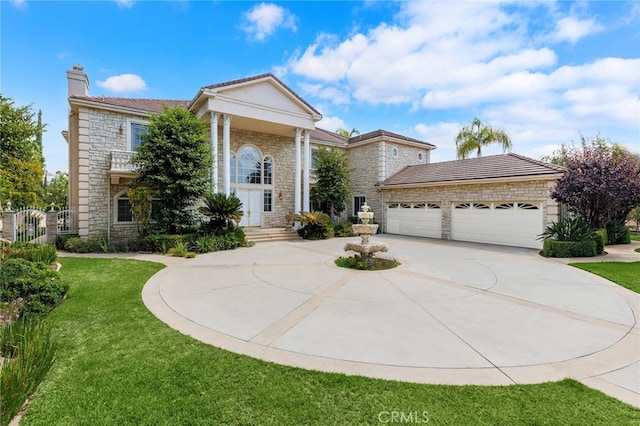 view of front of house with a front yard and a garage