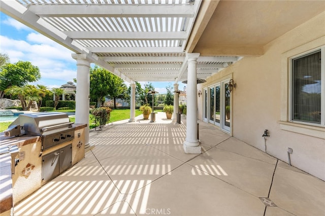 view of patio with area for grilling, a pergola, and grilling area