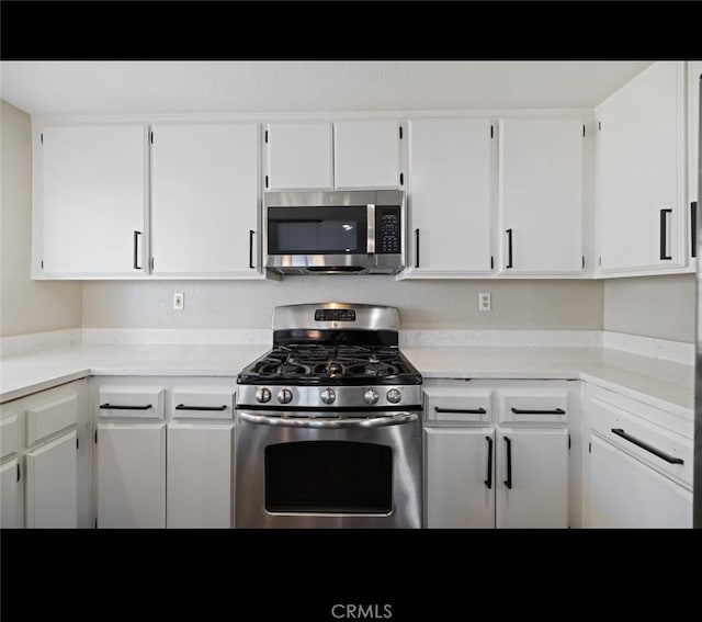 kitchen featuring white cabinets and appliances with stainless steel finishes