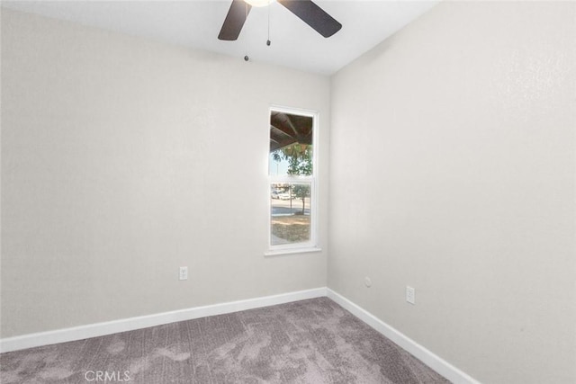 unfurnished room with ceiling fan and carpet