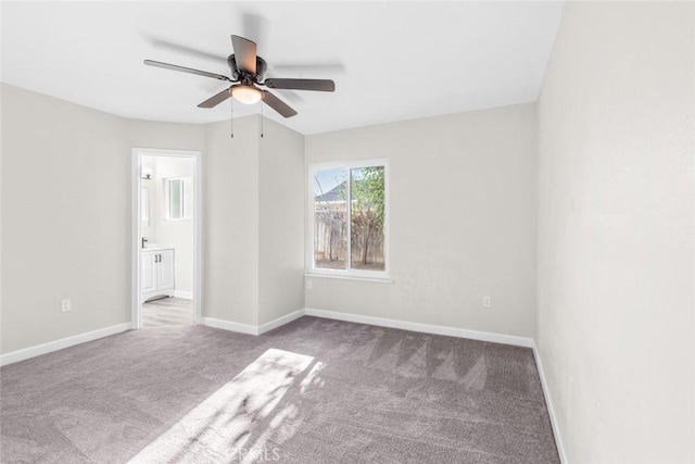 unfurnished bedroom featuring connected bathroom, light colored carpet, and ceiling fan