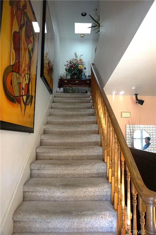 stairs with a skylight