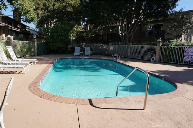 view of swimming pool with a patio area