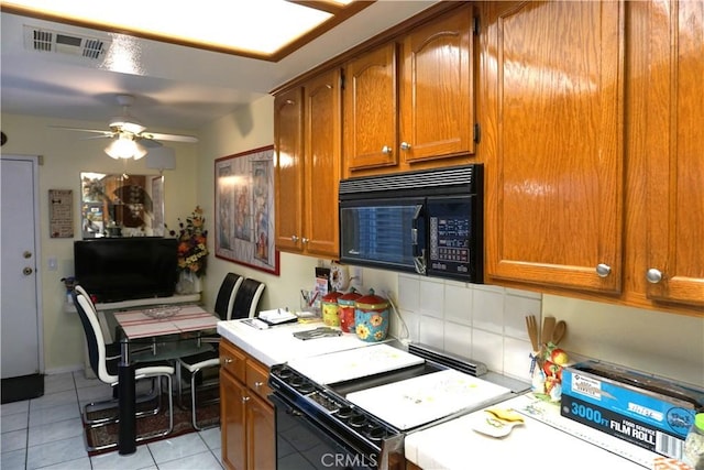 kitchen with ceiling fan, light tile patterned floors, and black appliances