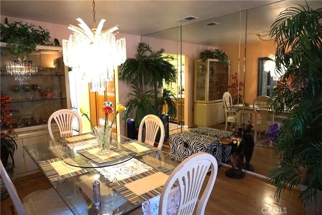 dining room featuring wood-type flooring and a notable chandelier