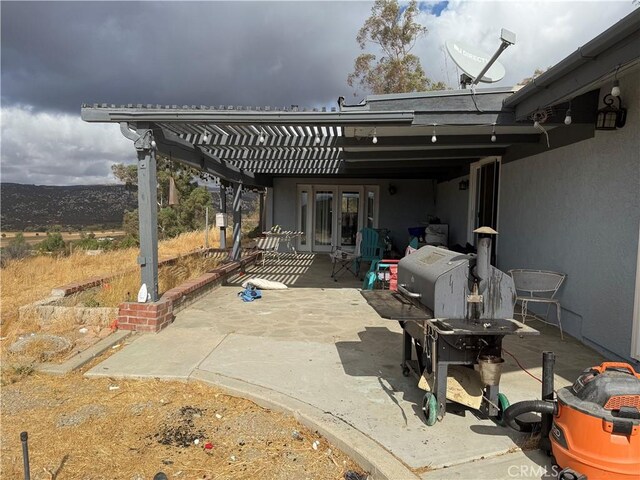 view of patio with french doors and a pergola