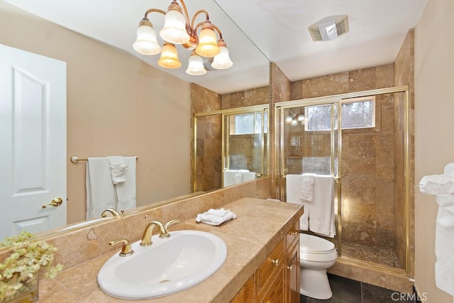 bathroom with vanity, an inviting chandelier, tile patterned floors, toilet, and an enclosed shower