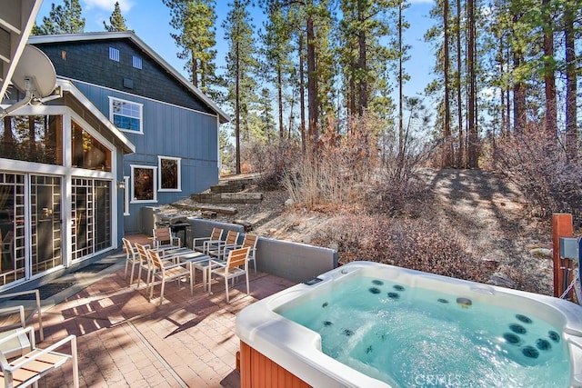 wooden deck featuring a patio area and a hot tub