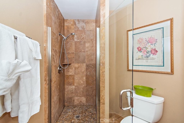 bathroom featuring an enclosed shower and toilet