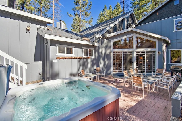 wooden terrace with a patio and a hot tub