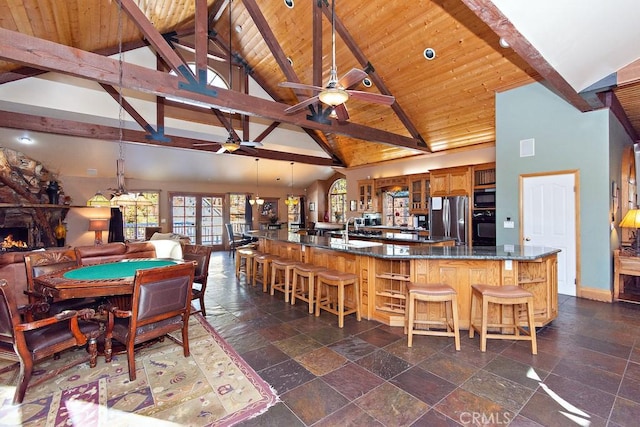 dining space featuring beam ceiling, wooden ceiling, and high vaulted ceiling