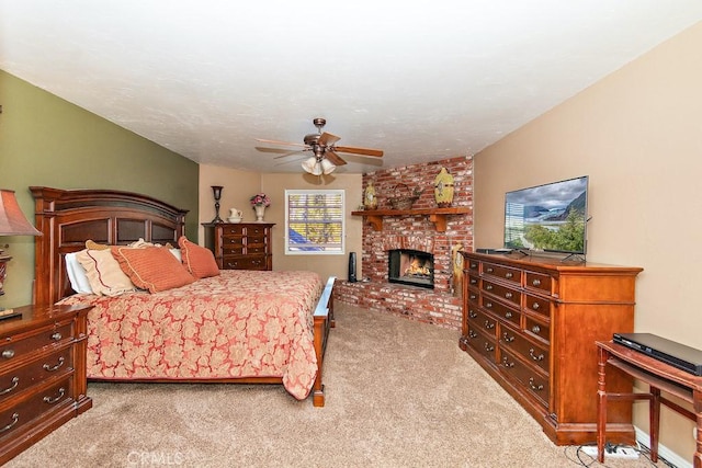 bedroom with ceiling fan, carpet floors, and a fireplace