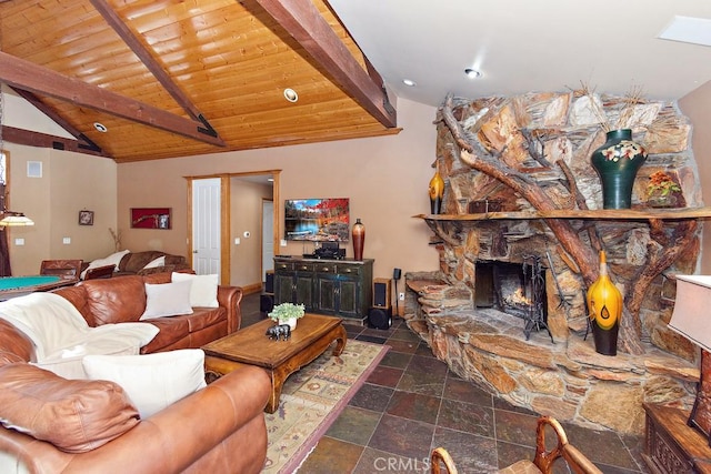 living room with lofted ceiling with beams, a stone fireplace, and wood ceiling