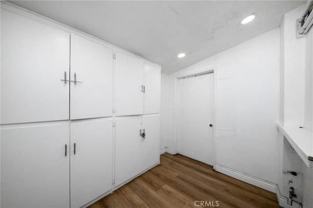 spacious closet with hardwood / wood-style floors and lofted ceiling