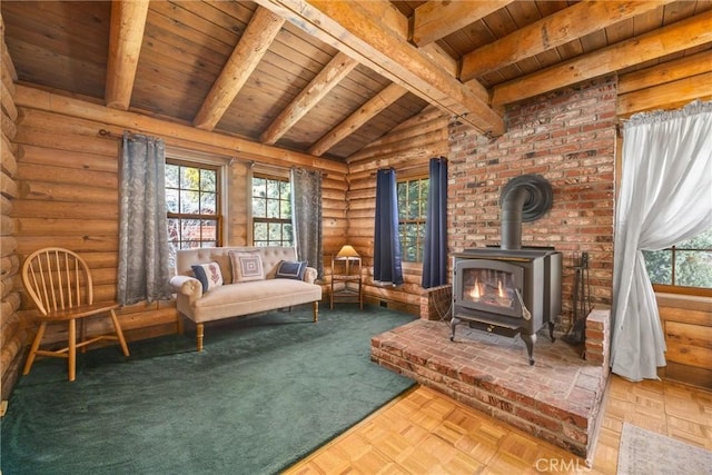 living area featuring vaulted ceiling with beams, a wood stove, rustic walls, and wooden ceiling