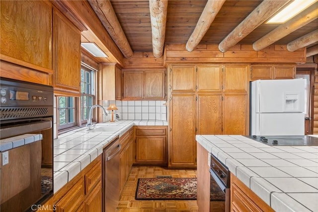 kitchen with decorative backsplash, tile counters, wooden ceiling, a sink, and black appliances