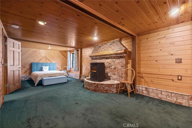 unfurnished bedroom featuring carpet flooring, wood walls, a wood stove, and wood ceiling