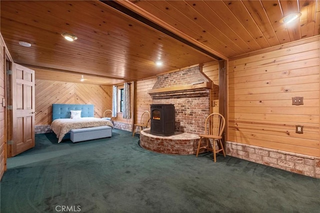 bedroom with wooden walls, carpet floors, a wood stove, and wood ceiling