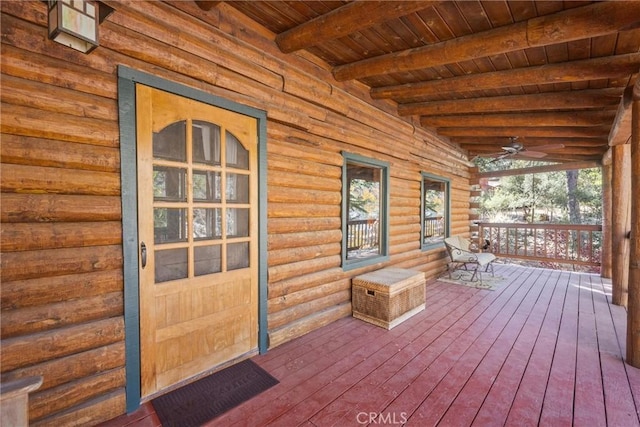 wooden terrace with a porch and a ceiling fan