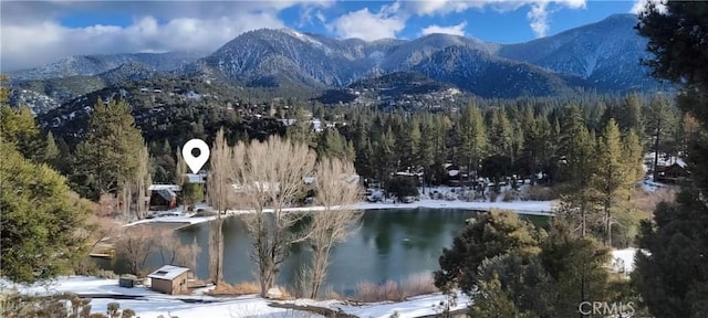 property view of mountains featuring a water view and a wooded view