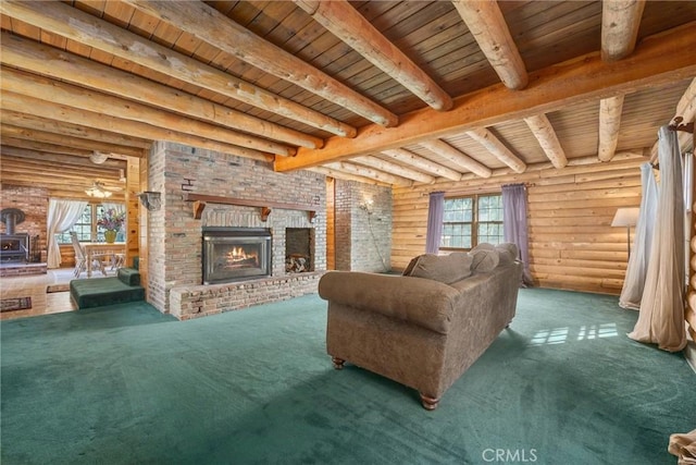 carpeted living room featuring ceiling fan, log walls, wooden ceiling, beamed ceiling, and a fireplace