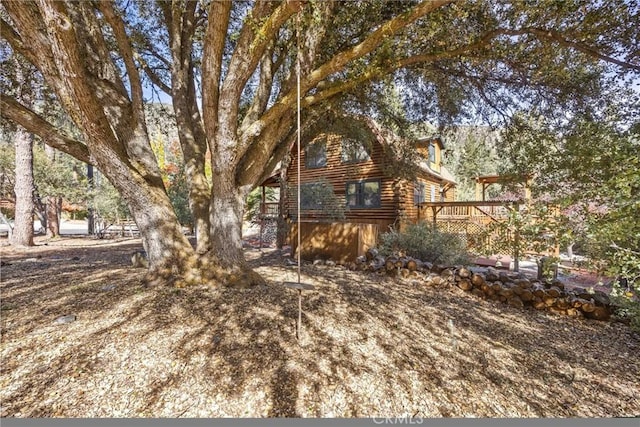 view of yard featuring a wooden deck