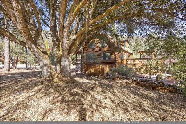 view of yard featuring a wooden deck
