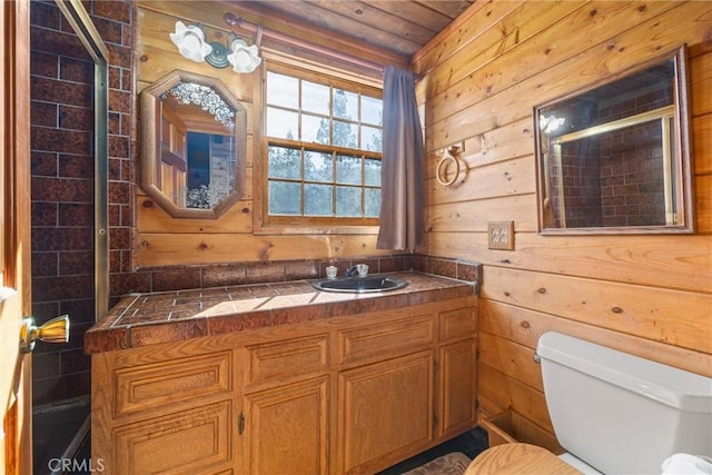 full bath featuring vanity, walk in shower, wooden walls, and toilet